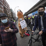 
              Counter protesters disperse to other locations after blocking a convoy of truckers opposed to COVID-19 health measures and vaccinations, in Vancouver, British Columbia, Saturday, Feb. 5, 2022. A group of more than 200 counter protesters on foot and on bikes held up the convoy for nearly an hour before police officers turned the trucks around and sent them on another route. (Darryl Dyck/The Canadian Press via AP)
            