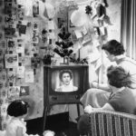 
              FILE - A London family looks at Queen Elizabeth II on a television screen during her majesty's first Christmas day telecast to the British people on Dec. 26, 1957. Listening to the Queen are Mrs. Sidney Smart and her daughters, Sandra, 4, left, and Barbara, 15, right. Britain is marking Queen Elizabeth II's Platinum Jubilee on Sunday, Feb. 6, 2022,  70 years after she ascended to the throne. (AP Photo, File)
            