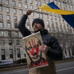 
              Supporters of Ukrainian sovereignty protest the Russian invasion of Ukraine, Thursday, Feb. 24, 2022, in New York. World leaders Thursday condemned Russia's invasion of Ukraine as "barbaric" and moved to slap unprecedented economic sanctions on Moscow and those close to President Vladimir Putin. (AP Photo/John Minchillo)
            