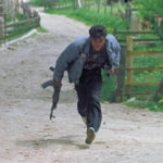 
              FILE - A Bosnian militiaman runs for cover in the hills above Sarajevo, May 12, 1992. It was there for all to see when the Balkan war over the split-up of Yugoslavia dominated the 1990s. Former Luxembourg Foreign Minister Jacques Poos boldly declared it was "the hour of Europe," yet it took U.S. led NATO troops to make the difference and the Bosnian war was ended in 1995 with a U.S. brokered deal in the Ohio town of Dayton, not in Europe. (AP Photo/Santiago Lyon, File)
            
