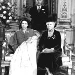 
              FILE - Britain's Princess Elizabeth, later Queen Elizabeth II, holds her son Prince Charles at Buckingham Palace, following his christening, in London, Dec. 15, 1948. Seated at right is her grandmother Queen Mary, the mother of her father, King George VI, background. Queen Elizabeth II will mark 70 years on the throne Sunday, Feb. 6, 2022 an unprecedented reign that has made her a symbol of stability as the United Kingdom navigated an age of uncertainty. (Pool via AP, File)
            
