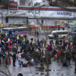 
              People try to get onto buses to leave Kyiv, Ukraine, Thursday, Feb. 24, 2022. Russia has launched a barrage of air and missile strikes on Ukraine early Thursday and Ukrainian officials said that Russian troops have rolled into the country from the north, east and south. (AP Photo/Emilio Morenatti)
            