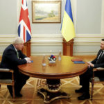 
              Britain's Prime Minister Boris Johnson, left, sits opposite Ukrainian President Volodymyr Zelenskyy, during their talks amid rising tension between Ukraine and Russia, at the presidential palace, in Kyiv, Ukraine, Tuesday, Feb. 1, 2022.  (Peter Nicholls/Pool Photo via AP)
            