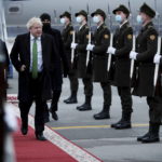 
              Britain's Prime Minister Boris Johnson, centre, arrives in Kyiv, Ukraine, Tuesday, Feb. 1, 2022. Johnson is scheduled to meet with Ukrainian President Volodymyr Zelenskyy amid rising tensions with Russia. (Peter Nicholls/Pool Photo via AP)
            
