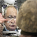 
              A Ukrainian serviceman adjusts a bullet riddled effigy of Russian President Vladimir Putin, during a media interview at a frontline position in the Luhansk region, eastern Ukraine, Tuesday, Feb. 1, 2022. Russia accused the West of "whipping up tensions" over Ukraine and said the U.S. had brought "pure Nazis" to power in Kyiv as the U.N. Security Council held a stormy and bellicose debate on Moscow's troop buildup near its southern neighbor. (AP Photo/Vadim Ghirda)
            