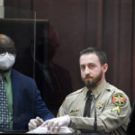 
              Davidson County County Sheriff's Cpl. Jacob Bianchi takes the styrofoam food container out of an evidence bag, that has a drawing by Travis Reinking, showing the Waffle House shooting, one year after the actual incident, during Reinking's murder trial in Nashville, Tenn., Thursday, Feb. 3, 2022. Reinking is charged with four counts of first degree murder, along with other attempted murder and weapons charges for a shooting in 2018 at a Nashville Waffle House. (Stephanie Amador/The Tennessean via AP, Pool)
            