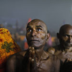 
              A Hindu pilgrim prays after taking a holy dip at Sangam, the confluence of the rivers Ganges and the Yamuna on 'Mauni Amavasya' or new moon day, third and the most auspicious date of bathing day during the annual month long Hindu religious fair "Magh Mela" In Prayagraj, India. Tuesday, Feb. 1, 2022. Hundreds of thousands of Hindu pilgrims take dips in the confluence, hoping to wash away sins during the month-long festival. (AP Photo/Rajesh Kumar Singh)
            