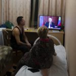 
              People from the Donetsk and Luhansk regions, the territory controlled by a pro-Russia separatist governments in eastern Ukraine, watch Russian President Vladimir Putin's address at their temporary place in Rostov-on-Don region, Russia, Monday, Feb. 21, 2022. Putin said he would decide later Monday whether to recognize the independence of separatist regions in eastern Ukraine, a move that would ratchet up tensions with the West amid fears that Moscow could launch an invasion of Ukraine imminently. (AP Photo/Denis Kaminev)
            