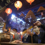 Worshippers pray during the lunar New Year celebrations at the Man Mo temple in Hong Kong Tuesday, Feb. 1, 2022. The celebration marks the Year of the Tiger in the Chinese Zodiac calendar. (AP Photo/Vincent Yu)