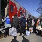 
              People from the Donetsk and Luhansk regions, the territory controlled by pro-Russia separatist governments in eastern Ukraine, get on a train to be taken to temporary residences in other regions of Russia, at the railway station in Taganrog, Russia, Monday, Feb. 21, 2022. World leaders are making another diplomatic push in hopes of preventing a Russian invasion of Ukraine, even as heavy shelling continues in Ukraine's east. (AP Photo)
            