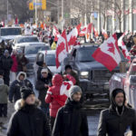 
              Trucks and supporters travel down Bloor Street during a demonstration in support of a trucker convoy in Ottawa protesting COVID-19 restrictions, in Toronto, Saturday, Feb. 5, 2022. (Nathan Denette/The Canadian Press via AP)
            