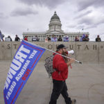 
              FILE - A supporters of President Donald Trump and people celebrating the victory of President-elect Joe Biden and Vice President-elect Kamala Harris, rear, stage a rally outside the Utah State Capitol on, Nov. 7, 2020, in Salt Lake City. Members of the Republican National Committee are scheduled to meet in Salt Lake City this week to discuss a series of measures solidifying former President Donald Trump's standing ahead of the midterm elections. Salt Lake City is one of the locations under consideration to host the Republican National Convention in 2024. Yet there are few overwhelmingly Republican states where Trump is as out of sync with the political culture as Utah, which prides itself on maintaining civility. (AP Photo/Rick Bowmer, File)
            