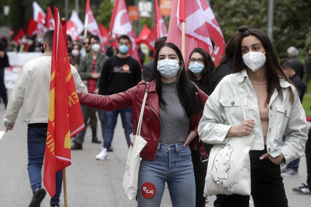FILE - People take part in the traditional May Day workers rally in Madrid, Spain, Saturday May 1, ...