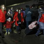 
              People from the Donetsk and Luhansk regions, the territory controlled by a pro-Russia separatist governments in eastern Ukraine, walk from a train to be taken to temporary residences in the Volgograd region, at the railway station in Volzhsky, Volgograd region, Russia, on Sunday, Feb. 20, 2022. Ukrainian President Volodymyr Zelenskyy, facing a sharp spike in violence in and around territory held by Russia-backed rebels and increasingly dire warnings that Russia plans to invade, has called for Russian President Vladimir Putin to meet him and seek a resolution to the crisis. (AP Photo/Alexandr Kulikov)
            