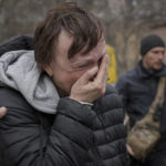 
              A woman evacuated from Irpin cries upon arriving on the outskirts of Kyiv, Ukraine, Saturday, March 26, 2022. Russia continues to pound cities throughout Ukraine — explosions rang out Saturday near the western city of Lviv, a destination for refugees that has been largely spared from major attacks.(AP Photo/Vadim Ghirda)
            