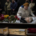 
              Natalya mourns the death of her brother Sergiy Muravyts'kyi, 61, who was killed during a Russian attack in the village of Mriya, which means Dream in Ukrainian, during a ceremony before his cremation at the Baikove cemetery, Kyiv, Ukraine, Thursday, March 24, 2022. (AP Photo/Rodrigo Abd)
            
