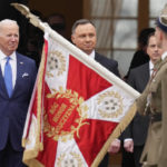 
              U.S. President Joe Biden, left, and Polish President Andrzej Duda, center, attend a military welcome ceremony at the Presidential Palace in Warsaw, Poland, on Saturday, March 26, 2022. (AP Photo/Czarek Sokolowski)
            