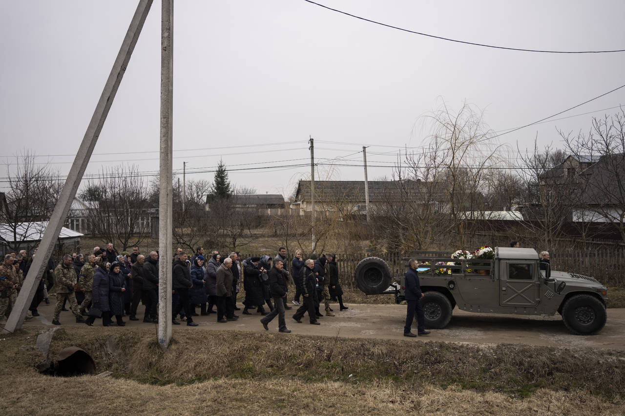People attend a funeral ceremony for Ukrainian military servicemen Roman Rak and Mykola Mykytiuk in...