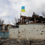
              A Ukrainian flag is installed on an apartment building damaged by fighting between Russian and Ukrainian troops in a village of Lukyanivka, Kyiv region, Ukraine, Sunday, March 27, 2022. (AP Photo)
            
