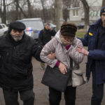 
              Residents evacuated from Irpin arrive at an assistance center on the outskirts of Kyiv, Ukraine, Wednesday, March 30, 2022. (AP Photo/Rodrigo Abd)
            