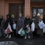 
              Residents wait in line to receive aid from the Ukrainian Red Cross in Kharkiv, Ukraine, Thursday, March 24, 2022. (AP Photo/Felipe Dana)
            