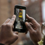 
              A person records video of the marquee advertising Chris Rock outside the Wilbur Theatre, Wednesday, March 30, 2022, in Boston. (AP Photo/Mary Schwalm)
            