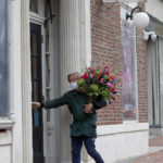 
              A florist delivers flowers addressed to Chris Rock at the Wilbur Theatre before a performance, Wednesday, March 30, 2022, in Boston. (AP Photo/Mary Schwalm)
            