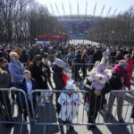 
              People wait in a line at a special application point at the National Stadium in Warsaw, Poland, on Monday, March 21, 2022, to apply for Polish ID numbers that will entitle them to work and receive free health care and education. (AP Photo/Czarek Sokolowski)
            