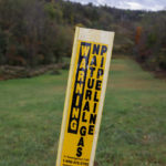 
              FILE - This Oct. 17, 2019, photo, shows a post that marks the location of a shale gas pipeline in Zelienople, Pa. Amid pushback from industry and lawmakers in both parties, federal energy regulators on Thursday, March 24, 2022, scaled back plans to consider how natural gas projects affect climate change and environmental justice. (AP Photo/Keith Srakocic, File)
            
