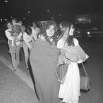 
              FILE - Two Dairyland Union School District students, who were among the 26 school children, and their bus driver who were abducted and buried in a truck underground, walk to the family car clad in blankets after release and early morning arrival in Chowchilla, Calif., on July 17, 1976. California parole commissioners have recommended parole for the last of three men convicted of hijacking the school bus full of children for $5 million ransom in 1976. The two commissioners acted Friday, March 25, 2022, in the case of 70-year-old Frederick Woods. (AP Photo, File)
            