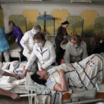 
              Medical workers move a patient in a basement of a maternity hospital converted into a medical ward and used as a bomb shelter in Mariupol, Ukraine, Tuesday, March 1, 2022. Russian strikes on the key southern port city of Mariupol seriously wounded several people. (AP Photo/Evgeniy Maloletka)
            