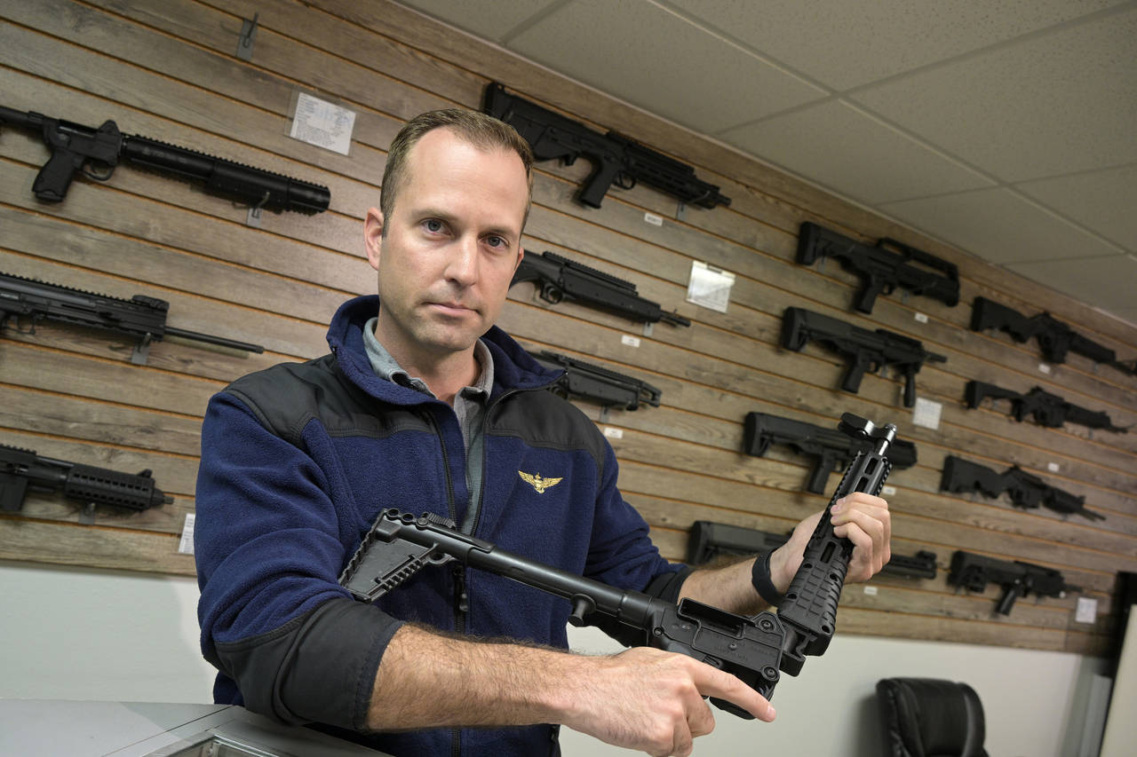 Adrian Kellgren, director of industrial production of KelTec, holds a 9mm SUB2000 rifle, similar to...