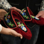 
              The President of the Metis community, Cassidy Caron and Mitchell Case, left, Community-based historian and educator and Region 4 Councillor, Metis Nation of Ontario, show to journalists a pair of traditional Metis pointed-toe style moccasin as a gift to Pope Francis in Rome, Monday, March 28, 2022. A Canadian indigenous delegations is scheduled to have a week of meetings with Pope Francis at the Vatican. (AP Photo/Gregorio Borgia)
            