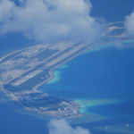 
              An airstrip made by China is seen beside structures and buildings at the man-made island on Mischief Reef at the Spratlys group of islands in the South China Sea are seen on Sunday March 20, 2022. A U.S. Navy plane carrying a top American military commander was threatened repeatedly by radio on Sunday to leave the airspace over Chinese-occupied island garrisons in the disputed South China Sea, but the aircraft pressed on defiantly with its reconnaissance in brief but tense standoffs witnessed by two Associated Press journalists invited onboard. (AP Photo/Aaron Favila)
            