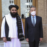
              In this photo released by Xinhua News Agency, Chinese Foreign Minister Wang Yi, right, poses for photos with Amir Khan Muttaqi, acting foreign minister of the Afghan Taliban's caretaker government, in Kabul, Afghanistan on March 24, 2022. Chinese leader Xi Jinping on Thursday, March 31, 2022 issued strong backing for Afghanistan at a regional conference, while making no mention of human rights abuses by the country's Taliban leaders. (Saifurahman Safi/Xinhua via AP)
            