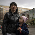 
              Julia, 34 , cries next to her daughter Veronika, 6, while talking to the press in Brovary, on the outskirts of Kyiv, Ukraine, Tuesday, March 29, 2022. (AP Photo/Rodrigo Abd)
            