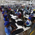 
              Workers tend to their jobs in a garment factory in Maseru, Lesotho, Thursday, Feb. 24, 2022. When the coronavirus pandemic hit the world two years ago, the global fashion industry crumpled when faced with collapsing demand, brands canceled orders worth billions of dollars and few felt the effects so harshly as the tens of millions of workers, most of them women, who stitched the world's clothes. (AP Photo/Neo Ntsoma)
            