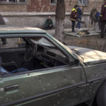 
              People clean up the streets after shelling damaged several apartments, in Kyiv, Ukraine, Wednesday, March 23, 2022.  (AP Photo/Rodrigo Abd)
            