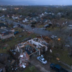 
              Debris litters the ground surrounding homes, damaged by a tornado, on Oxford Drive and Stratford Drive in Round Rock, Texas Monday, March 21, 2022. (Jay Janner/Austin American-Statesman via AP)
            