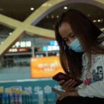 
              Liu Guizu, a migrant worker from Yunnan, looks at her phone while waiting for her flight at Kunming Changshui International Airport, Tuesday, March 22, 2022, in Kunming in southwest China’s Yunnan province. No survivors have been found yet among the 132 people onboard a China Eastern Boeing 737-800 that departed from Kunming and crashed Monday in the southern province of Guangxi. Liu said she still had hope that some had survived. (AP Photo/Dake Kang)
            