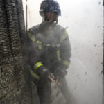 
              A Ukrainian firefighter shouts to a colleague while trying to extinguish a fire inside a house destroyed by shelling in Kyiv, Ukraine,Wednesday, March 23, 2022. The Kyiv city administration says Russian forces shelled the Ukrainian capital overnight and early Wednesday morning, in the districts of Sviatoshynskyi and Shevchenkivskyi, damaging buildings. (AP Photo/Rodrigo Abd)
            