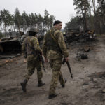 
              Ukrainian soldiers walk next to destroyed Russian tanks in the outskirts of Kyiv, Ukraine, Thursday, March 31, 2022. Russian forces shelled Kyiv suburbs, two days after the Kremlin announced it would significantly scale back operations near both the capital and the northern city of Chernihiv to “increase mutual trust and create conditions for further negotiations.” (AP Photo/Rodrigo Abd)
            