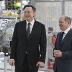 
              German Chancellor Olaf Scholz, right, and Elon Musk, Tesla CEO attend the opening of the Tesla factory Berlin Brandenburg in Gruenheide, Germany, Tuesday, March 22, 2022. The first European factory in Gr'nheide, designed for 500,000 vehicles per year, is an important pillar of Tesla's future strategy. (Patrick Pleul/Pool via AP)
            