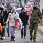
              Refugees from Ukraine cross into Poland at the Medyka crossing, Tuesday, March 1, 2022. Ambassadors from dozens of countries on Monday backed a proposal demanding that Russia halt its attack on Ukraine, as the U.N. General Assembly held a rare emergency session during a day of frenzied and sometimes fractious diplomacy surrounding the five-day-old war. (AP Photo/Markus Schreiber)
            