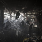
              Ukrainian soldiers and firefighters search for people under debris inside a shopping center after shelling, in Kyiv, Ukraine, Monday, March 21, 2022. (AP Photo/Felipe Dana)
            