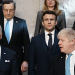 
              British Prime Minister Boris Johnson, front right, looks toward U.S. President Joe Biden, front left, at a group photo during an extraordinary NATO summit at NATO headquarters in Brussels, Thursday, March 24, 2022. As the war in Ukraine grinds into a second month, President Joe Biden and Western allies are gathering to chart a path to ramp up pressure on Russian President Vladimir Putin while tending to the economic and security fallout that's spreading across Europe and the world. (AP Photo/Thibault Camus)
            