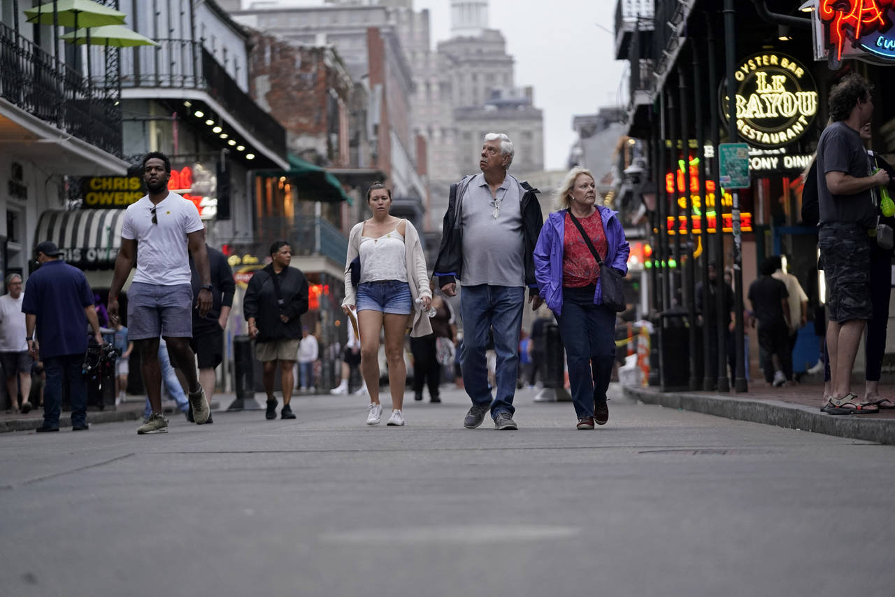People walk in the French Quarter Wednesday, March 30, 2022., in New Orleans. Few things in the spo...