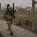 
              A Ukrainian serviceman walks by an animal which was killed during fighting at a heavily damaged private zoo while soldiers and volunteers attempted to evacuate the surviving animals to safety in the village of Yasnohorodka, on the outskirts of Kyiv, Ukraine, Wednesday, March 30, 2022. The evacuation was halted before completion as shelling resumed between Russian and Ukrainian forces in the area.(AP Photo/Vadim Ghirda)
            