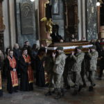 
              FILE - Ukrainian soldiers carry the coffin of one of the Ukrainian military servicemen, who were killed during an airstrike on a military base in Yavoriv, during a funeral ceremony in Lviv, Ukraine, Tuesday, March 15, 2022. For his domestic audience, look for U.S. President Joe Biden, during back to back summits in Brussels, to once again underscore the heroics of the Ukrainian military and volunteers who have managed to hold off an imposing Russian military. (AP Photo/Bernat Armangue, File)
            