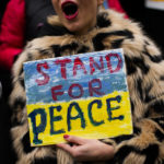 
              A Ukrainian woman holds a placard as she shouts slogans during a protest against Russia's invasion of Ukraine, in Istanbul, Turkey, Tuesday, March 1, 2022. Protests continue all over the world as Russian shelling pounded civilian targets in Ukraine's second-largest city Tuesday and a 40-mile convoy of tanks and other vehicles threatened the capital — tactics Ukraine's embattled president said were designed to force him into concessions in Europe's largest ground war in generations. (AP Photo/Francisco Seco)
            